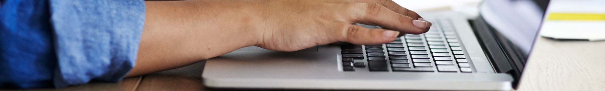 A person typing on a laptop