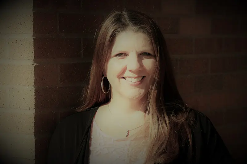 Tori Atkinson Standing next to a brick wall